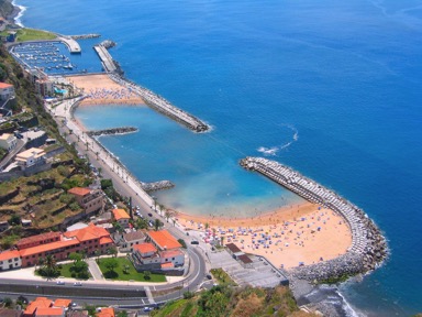 calheta beach with adults and children playing in the sea